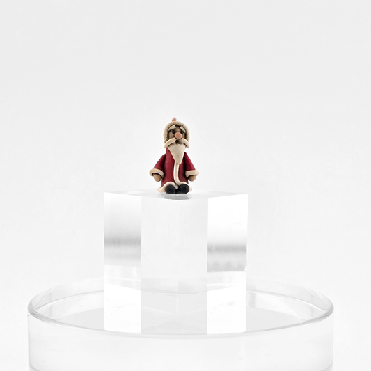 Miniature Folk Art Santa Figurine – Hand-Sculpted Clay on a white background