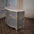 Load image into Gallery viewer, Decorative sideboard with marble top and gold leaf detailing in an ornate room.
