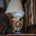 Load image into Gallery viewer, Decorative sculpture with a metal male figure on a black base in a warm, indoor miniature setting
