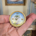 Load image into Gallery viewer, Ornate painted porcelain underside of  automata toy being held in hand
