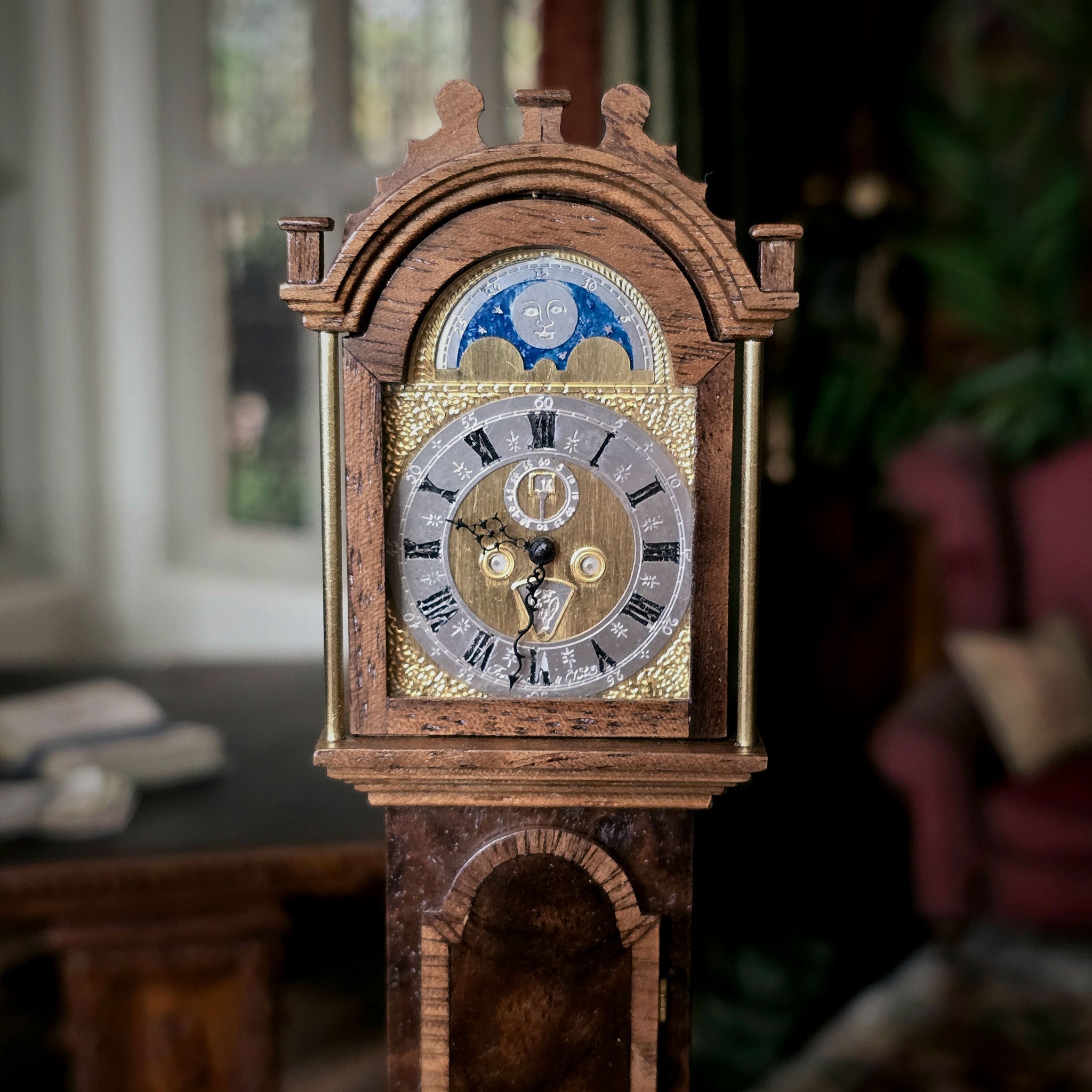 Wooden clock with detailed design in a blurred indoor setting