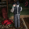 Load image into Gallery viewer, Dollhouse scene with a grandfather doll holding a child on a rug
