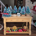 Load image into Gallery viewer, Decorative Christmas scene with miniature trees, presents, and a mug on a wooden table.
