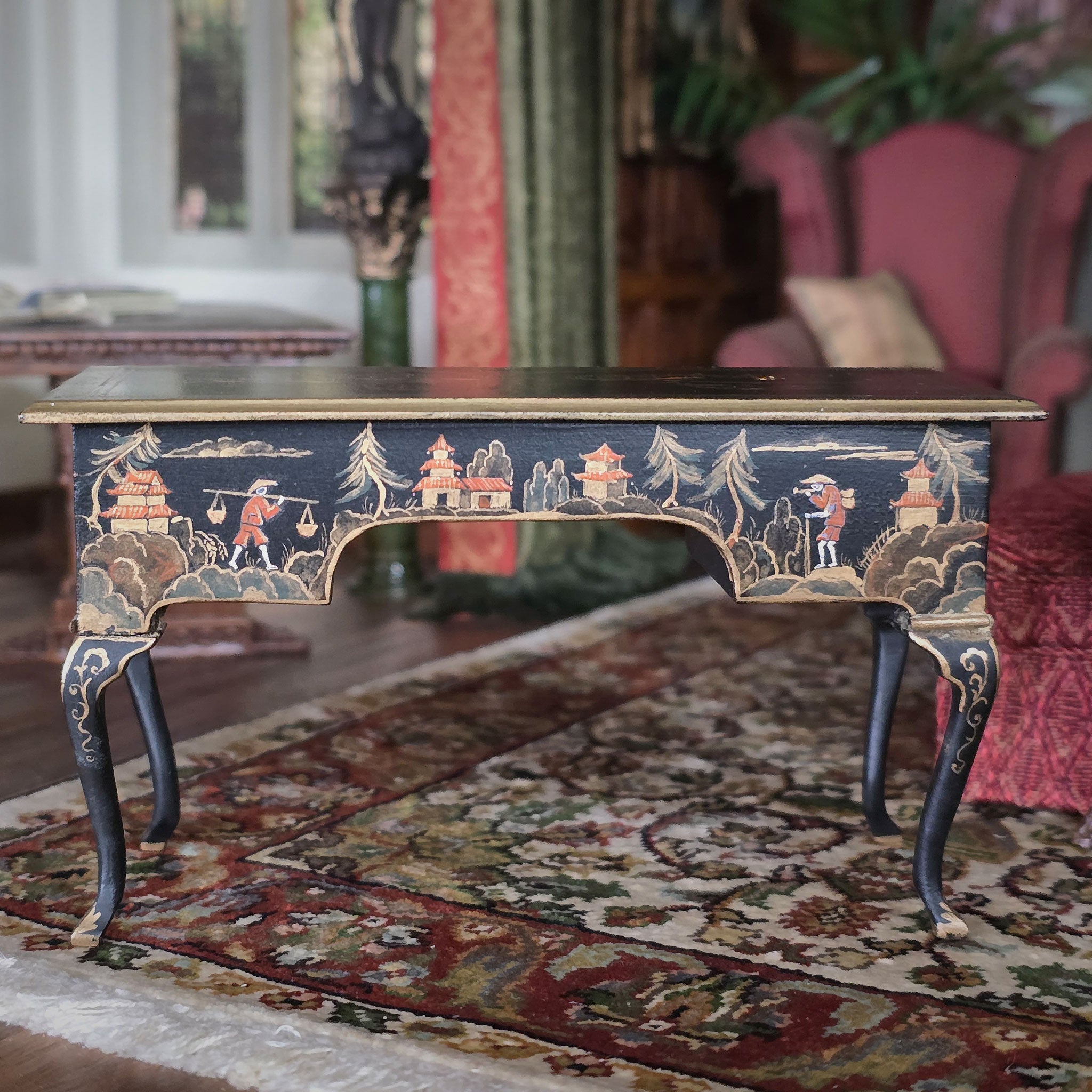 Decorative desk with intricate designs on a patterned rug