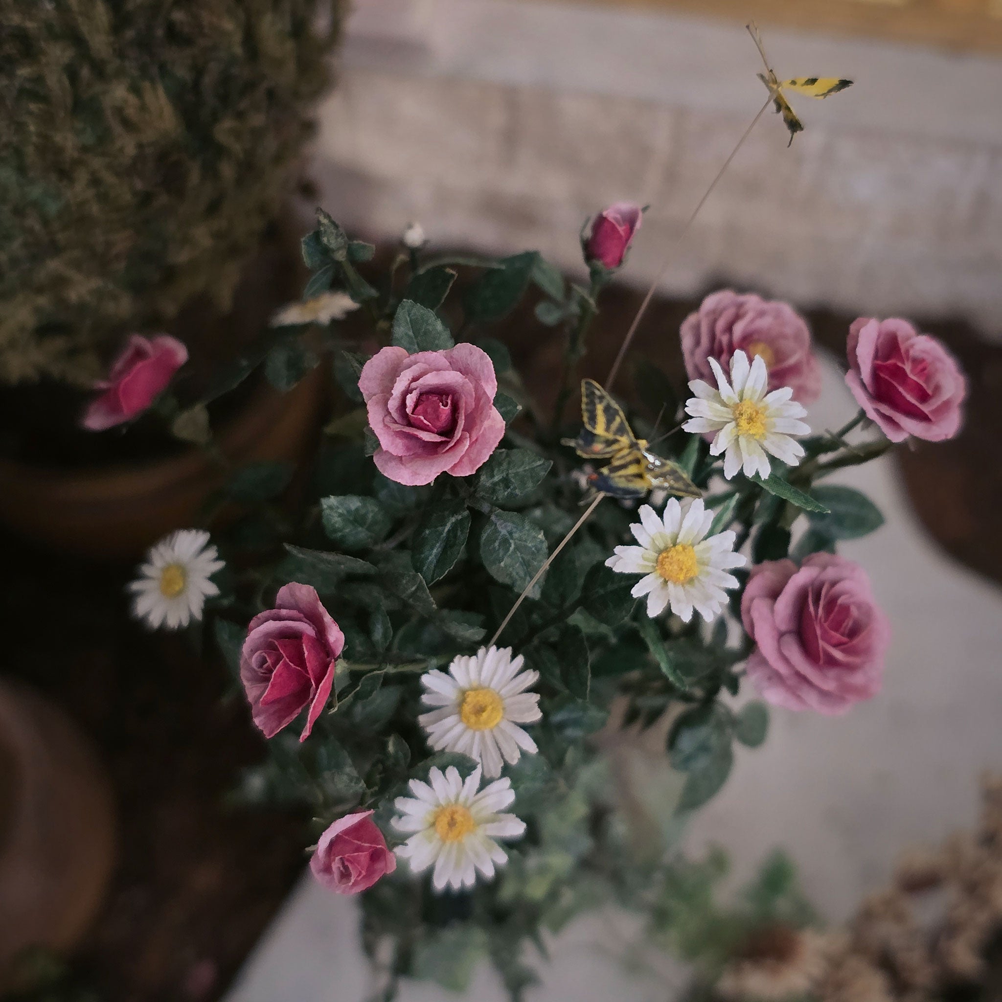 Bouquet of pink roses and white daisies with a blurred background