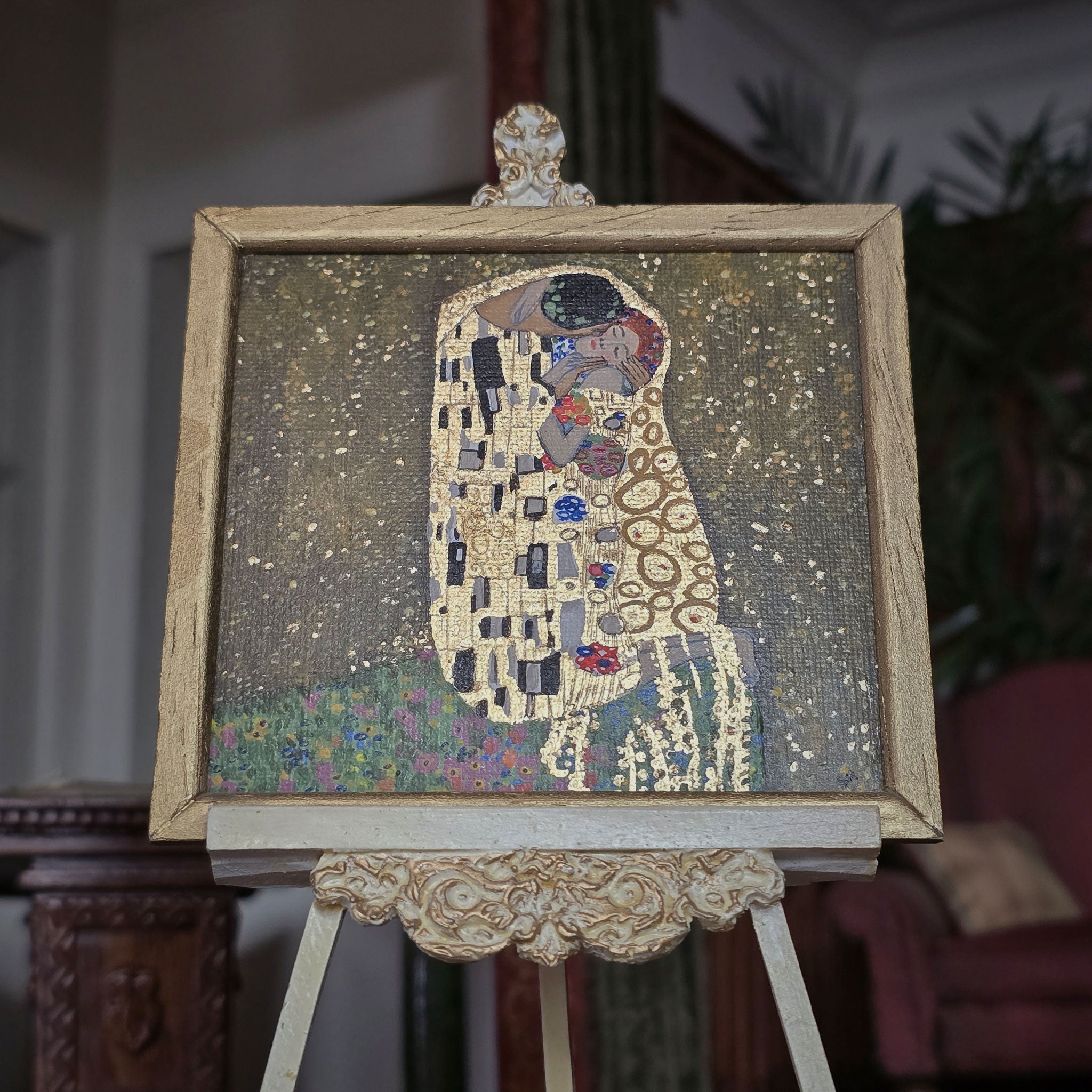 Framed painted art of 'The Kiss' by Gustav Klimt on an easel by Sam Kelm