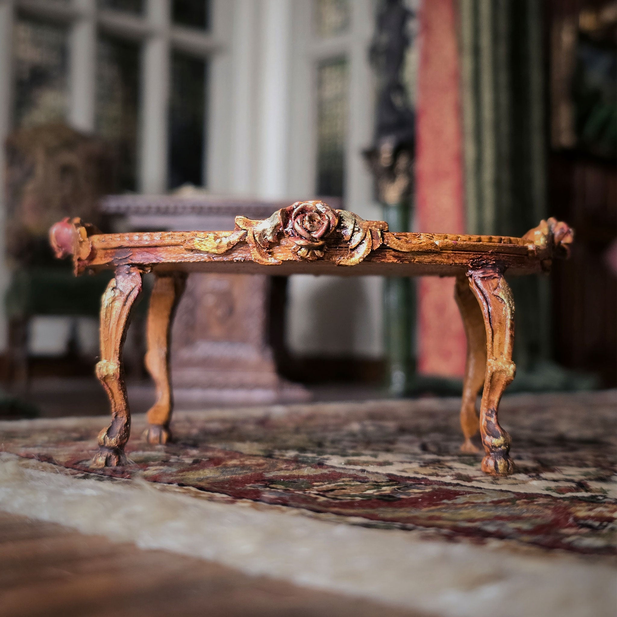 Decorative wooden bench with floral carvings on a patterned rug