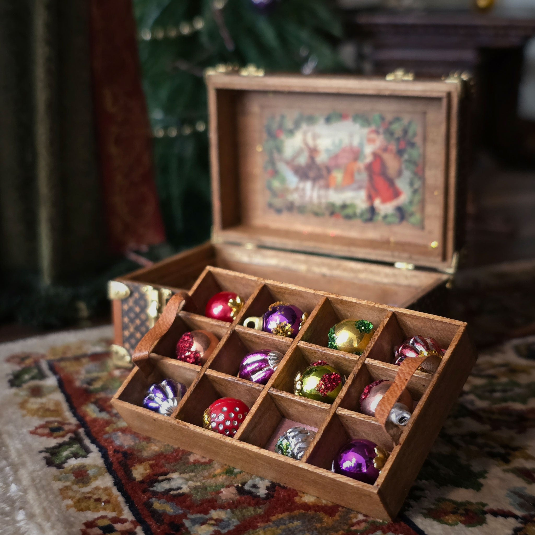 Wooden box with colorful Christmas ornaments on a patterned rug
