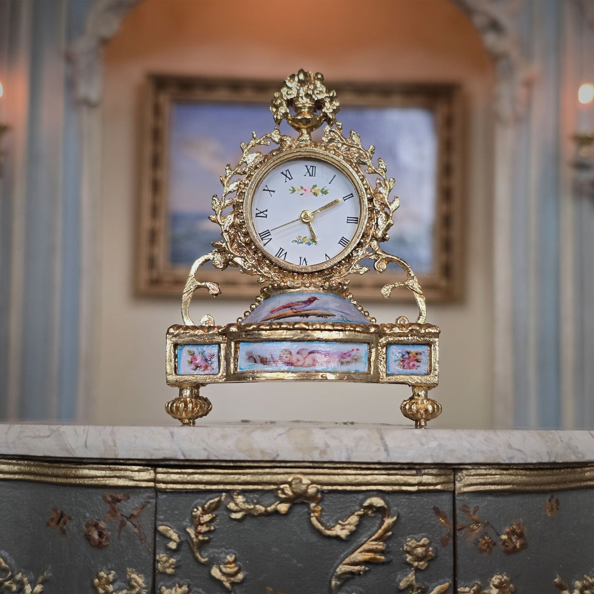 Decorative clock with gold accents on a marble surface - close up