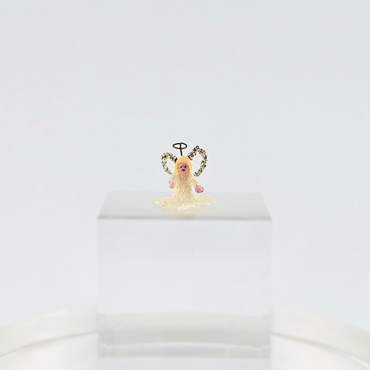 tiny angel tree topper for Christmas on a white background