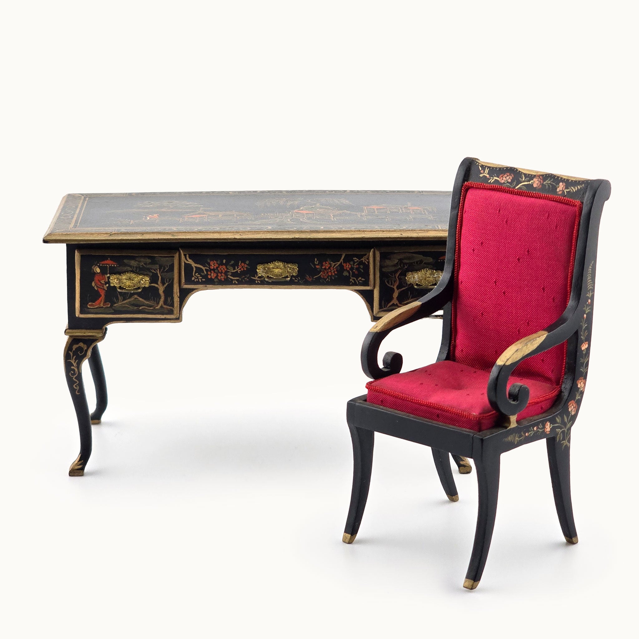 Decorative desk and chair with red cushion on a white background