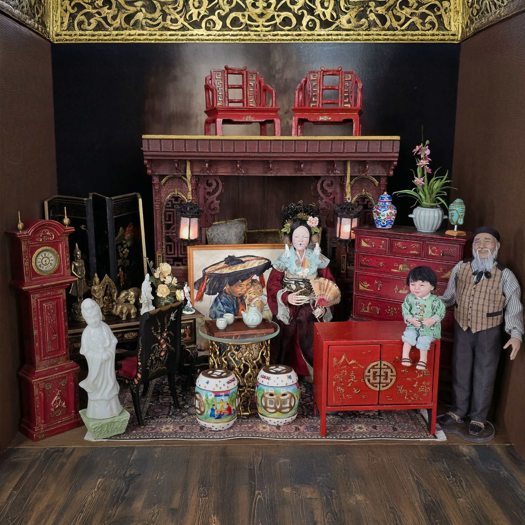 Miniature dollhouse scene with furniture, decor, and figures on a wooden floor.