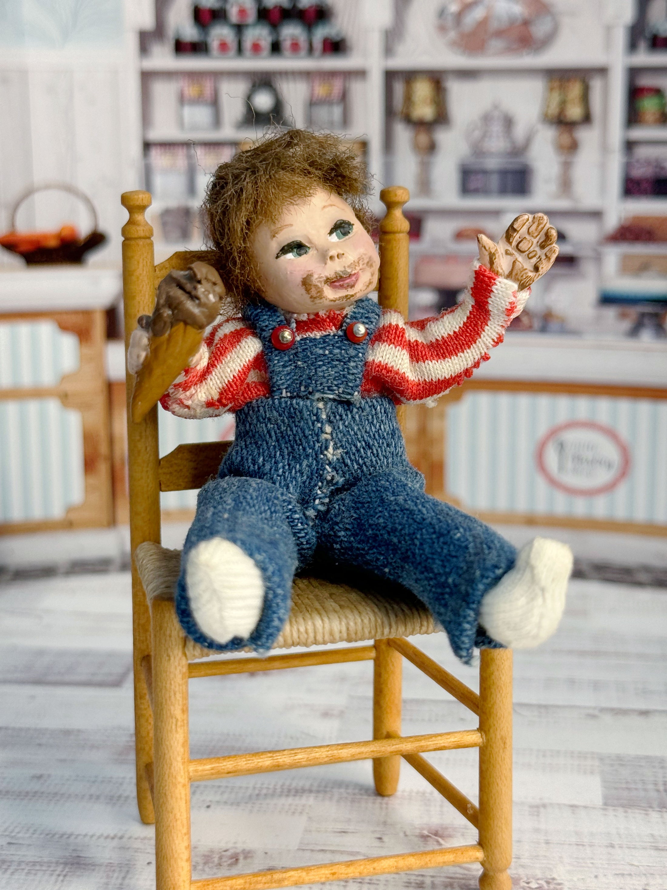 Messy Little Boy Doll with Overalls & Ice Cream Cone, sitting in chair