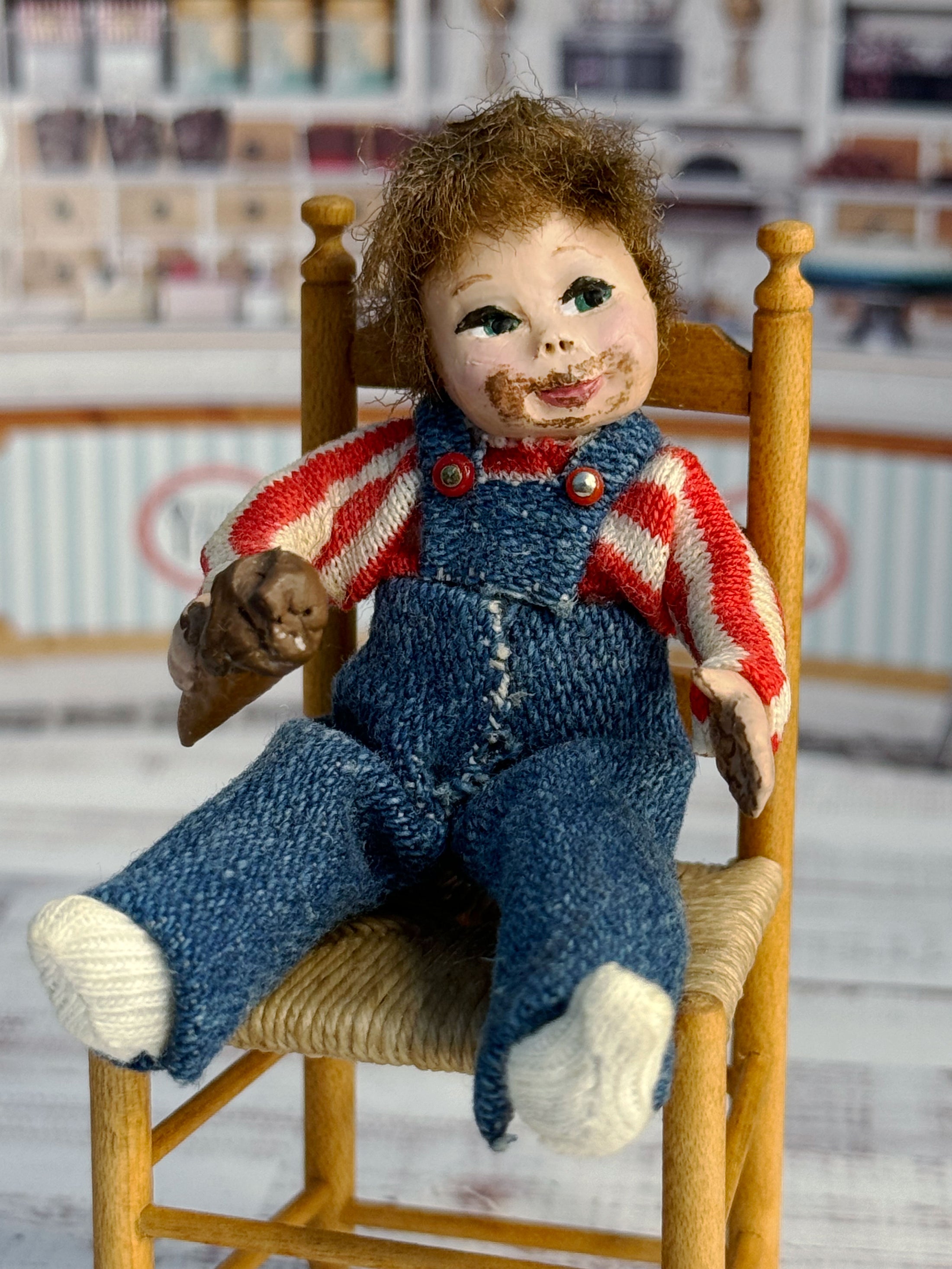 Messy Little Boy Doll with Overalls & Ice Cream Cone, sitting in chair