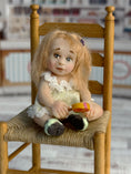 Load image into Gallery viewer, Sculpted Blonde Seated Young Girl Toddler Doll w Lollipop, sitting in chair
