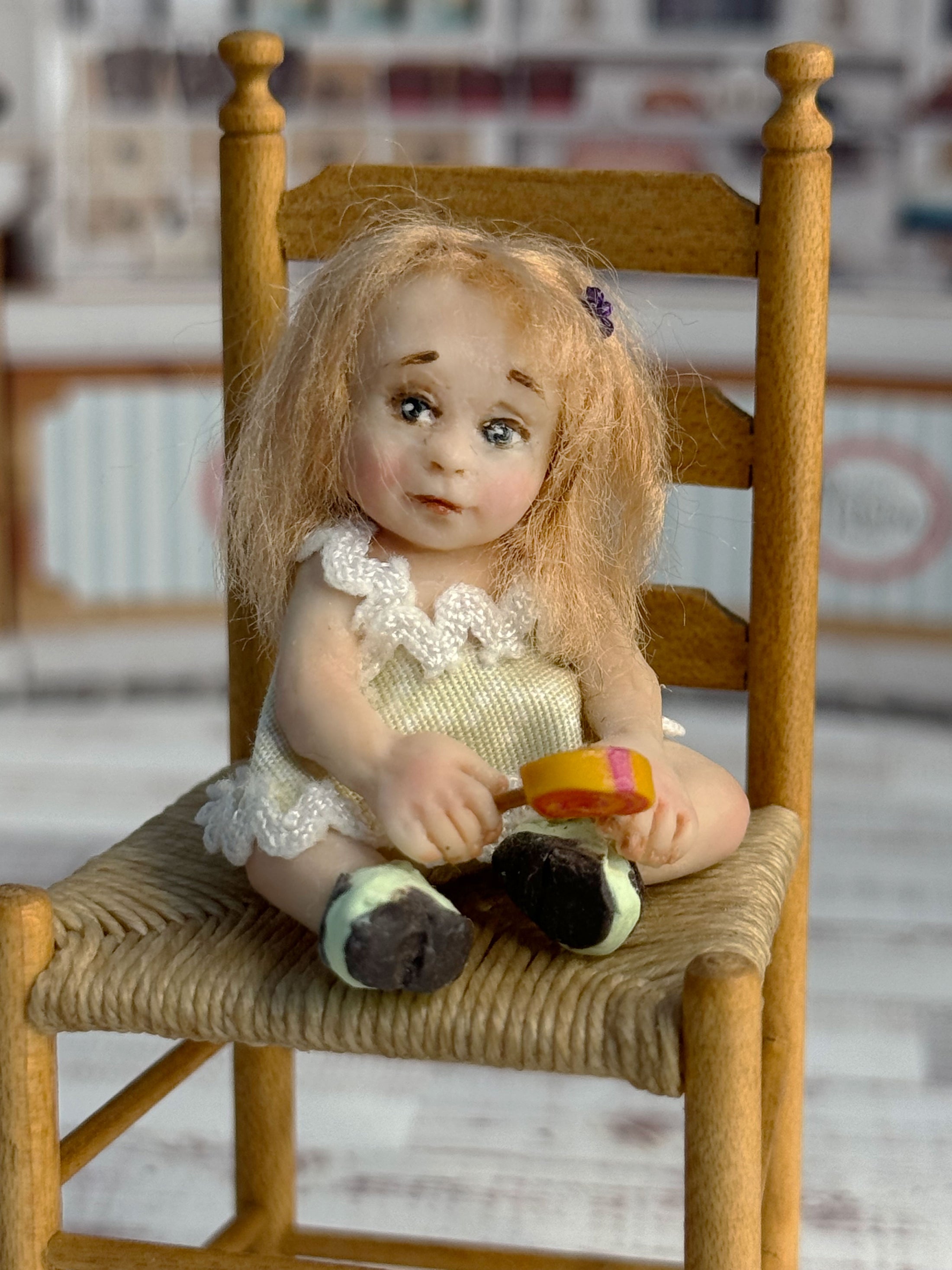 Sculpted Blonde Seated Young Girl Toddler Doll w Lollipop, sitting in chair