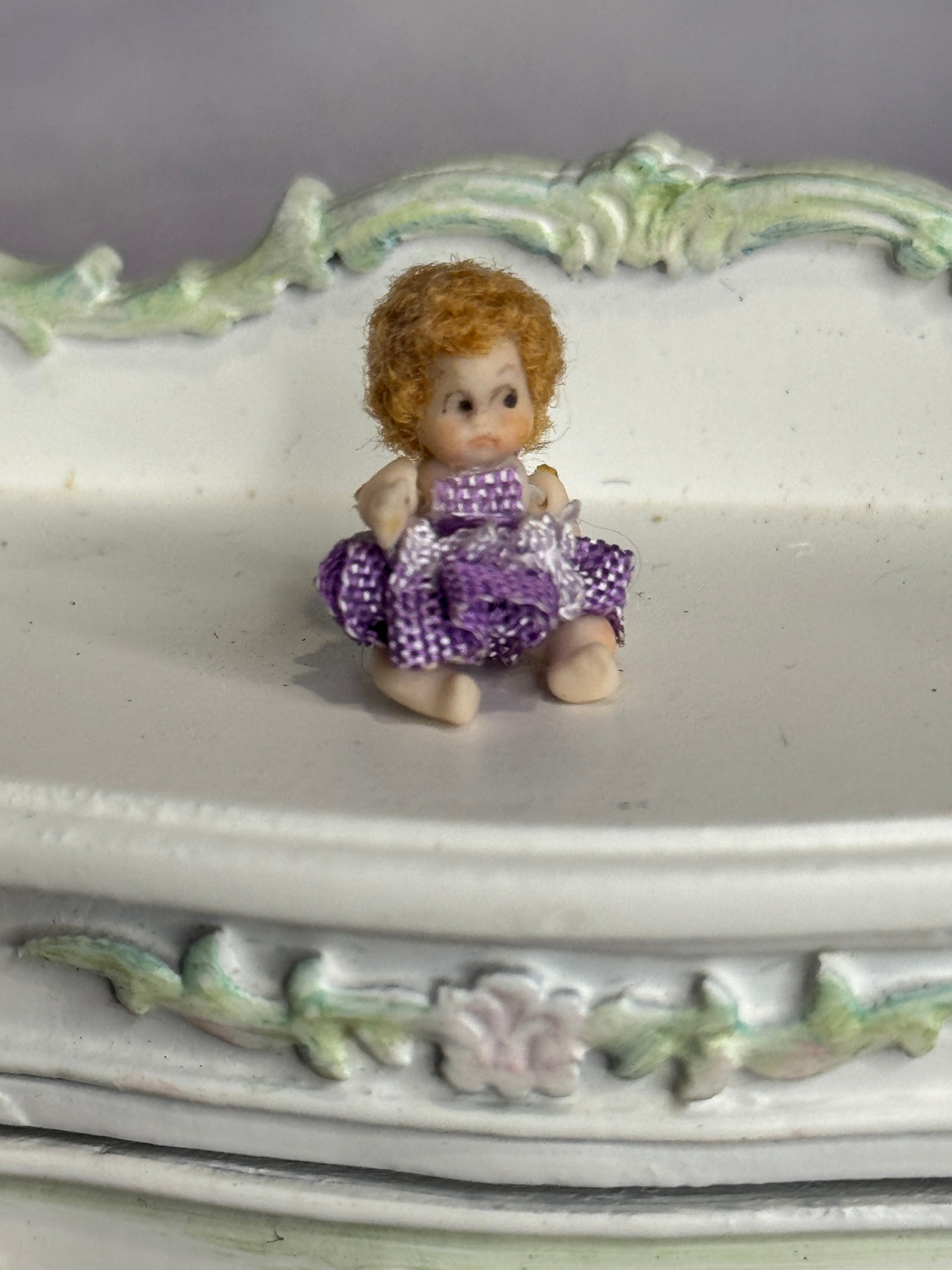 Sculpted Clay Jointed Baby Doll sitting on dresser