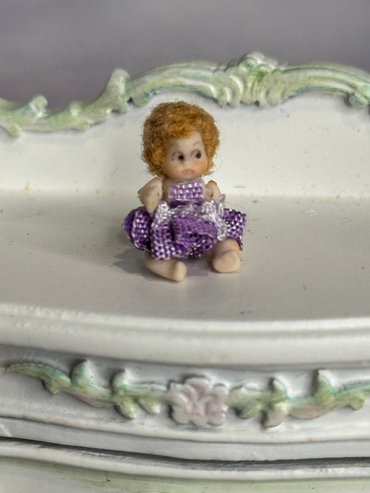 Sculpted Clay Jointed Baby Doll sitting on dresser
