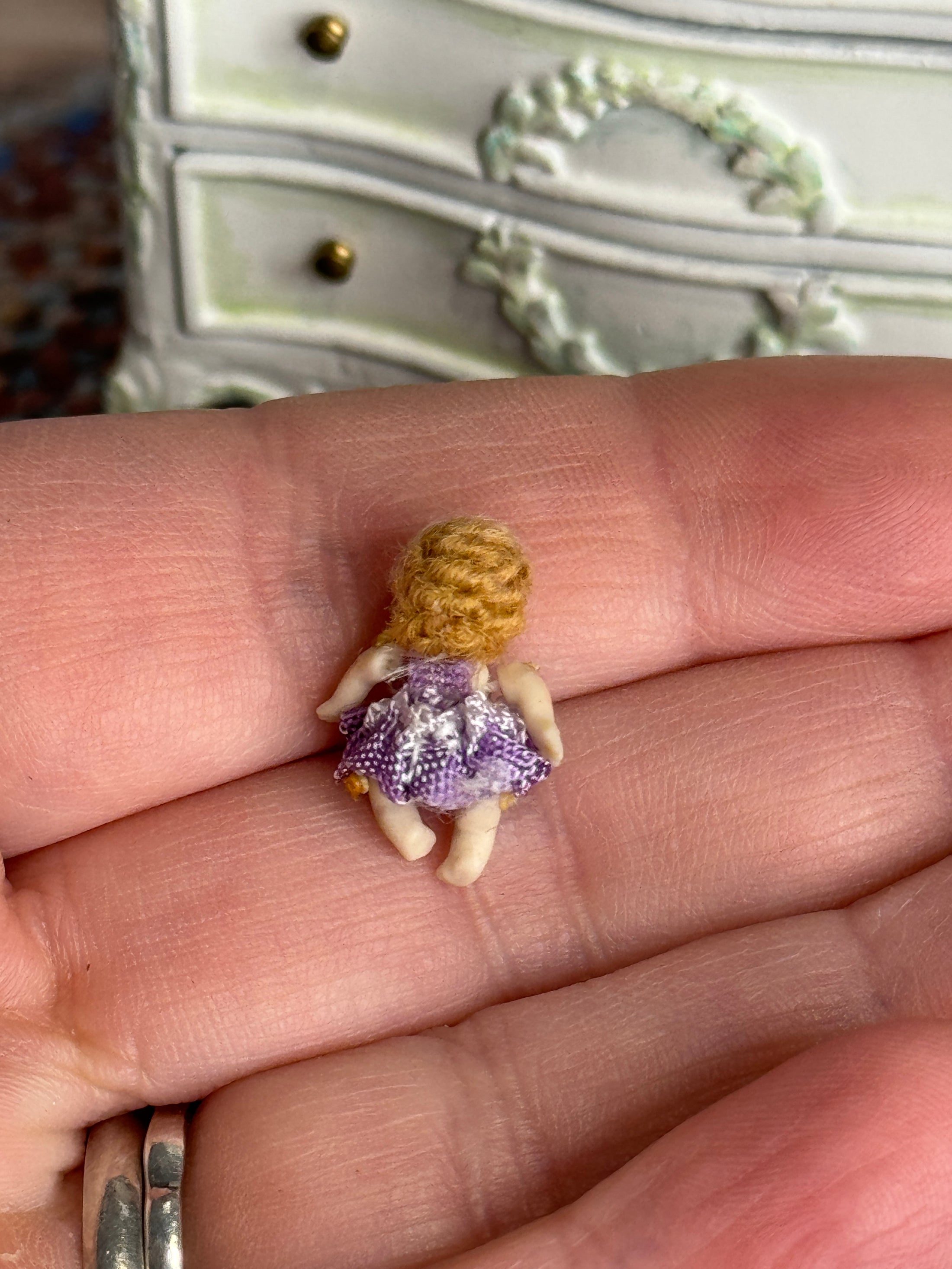 Sculpted Clay Jointed Baby Doll in open hand