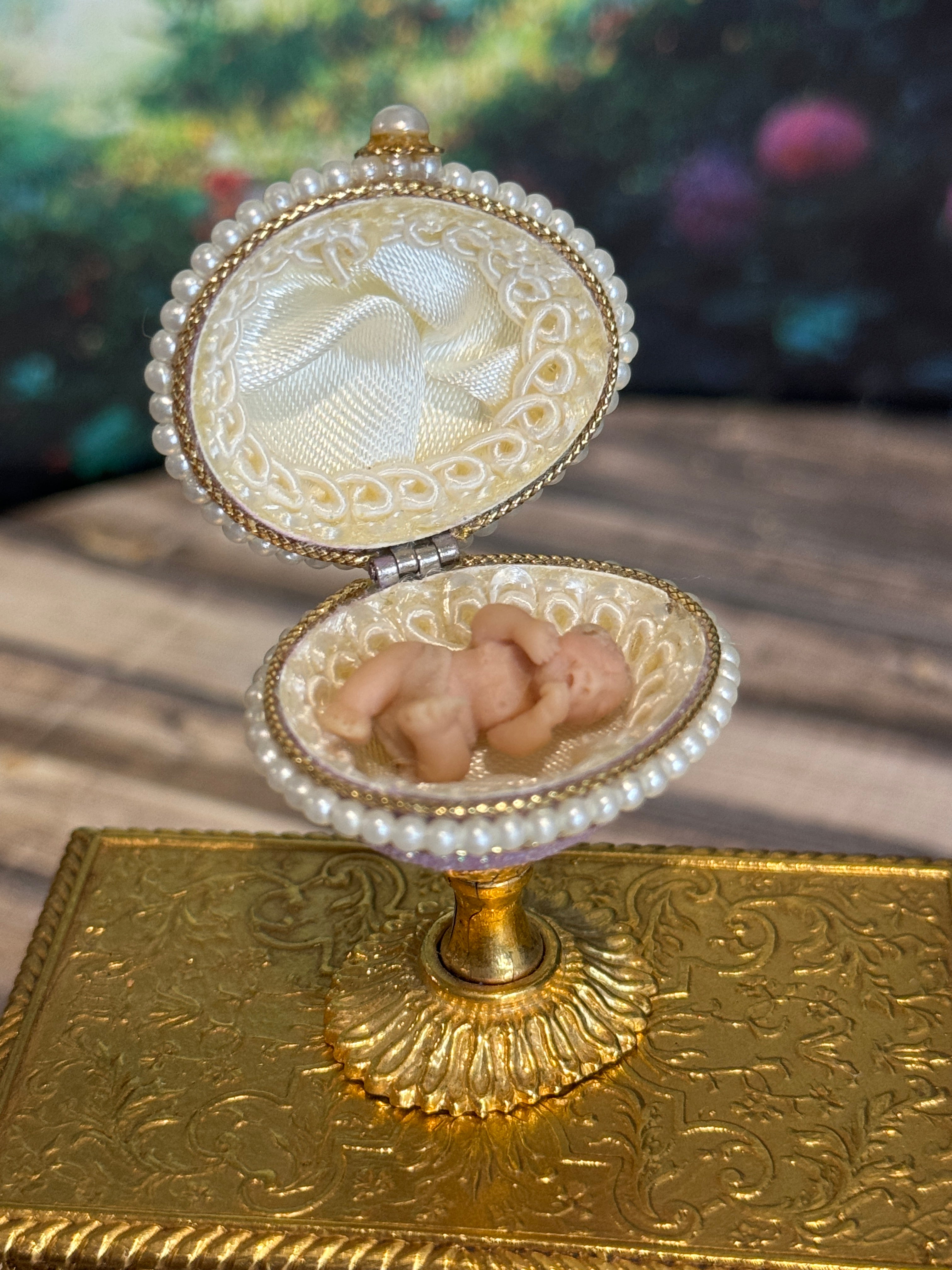 Artisan Signed, 'Hiller' sculpted vintage miniature baby in glittered footed pink egg stand, open view