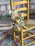 Load image into Gallery viewer, Robin Betterley Signed Sculpted Clay Blonde Toy Doll Holding Her Dolly 1984, sitting in tiny chair
