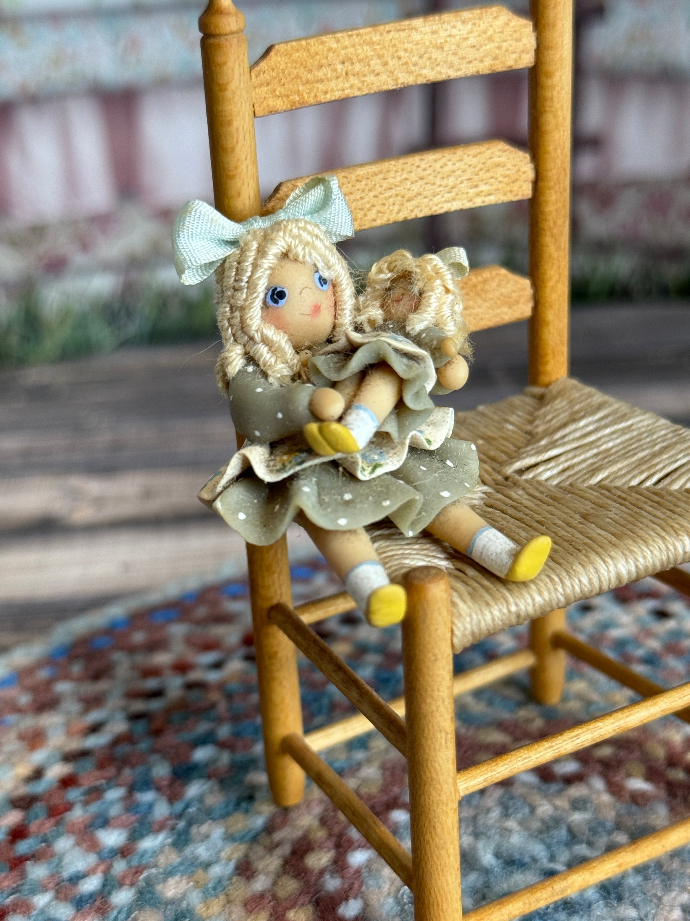 Robin Betterley Signed Sculpted Clay Blonde Toy Doll Holding Her Dolly 1984, sitting in tiny chair