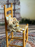Load image into Gallery viewer, Robin Betterley Signed Sculpted Clay Blonde Toy Doll Holding Her Dolly 1984, in chair, side view
