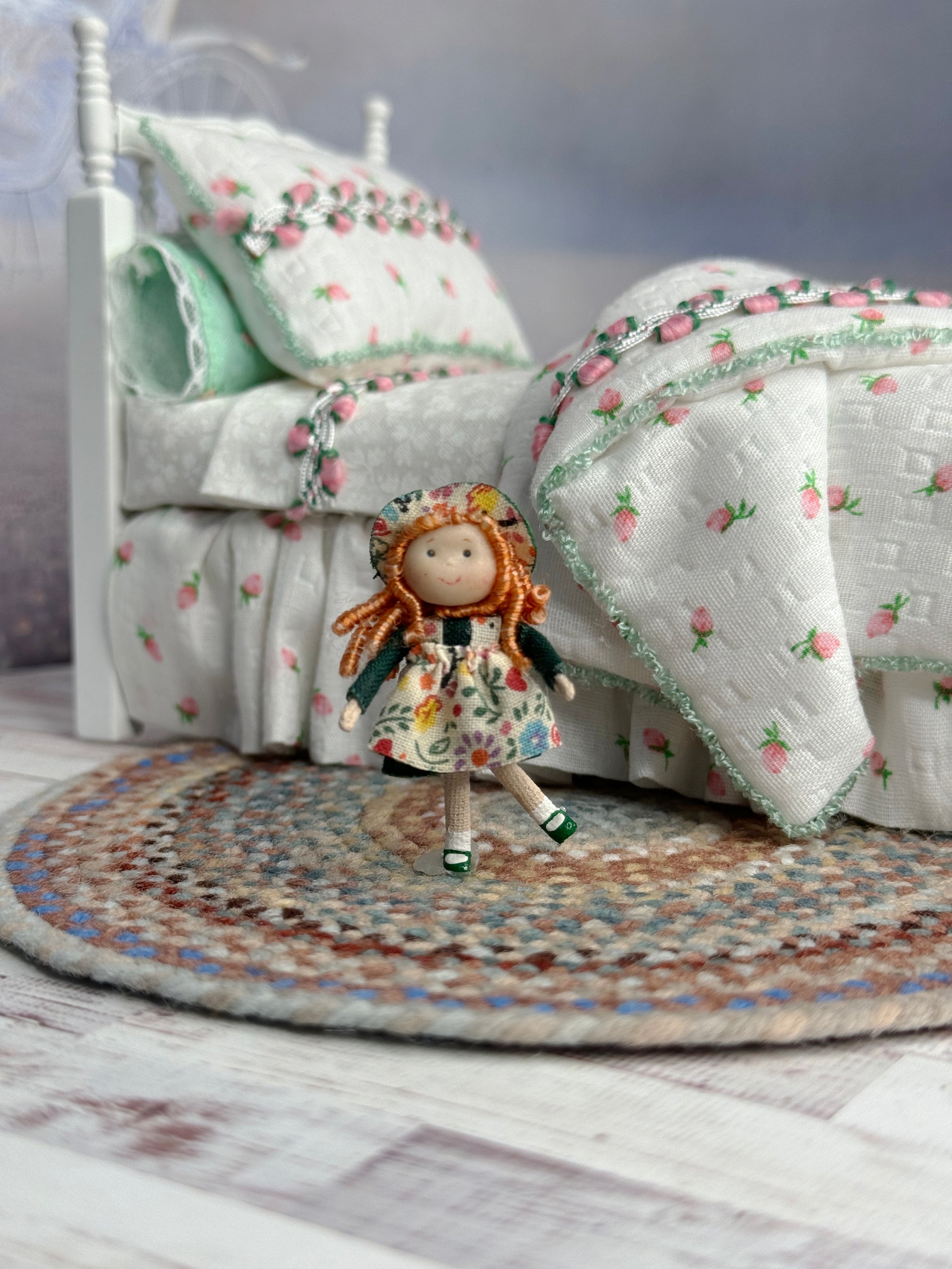 Ann Anderson Toy Dolly in Floral Spring Dress, standing in front of a child's bed