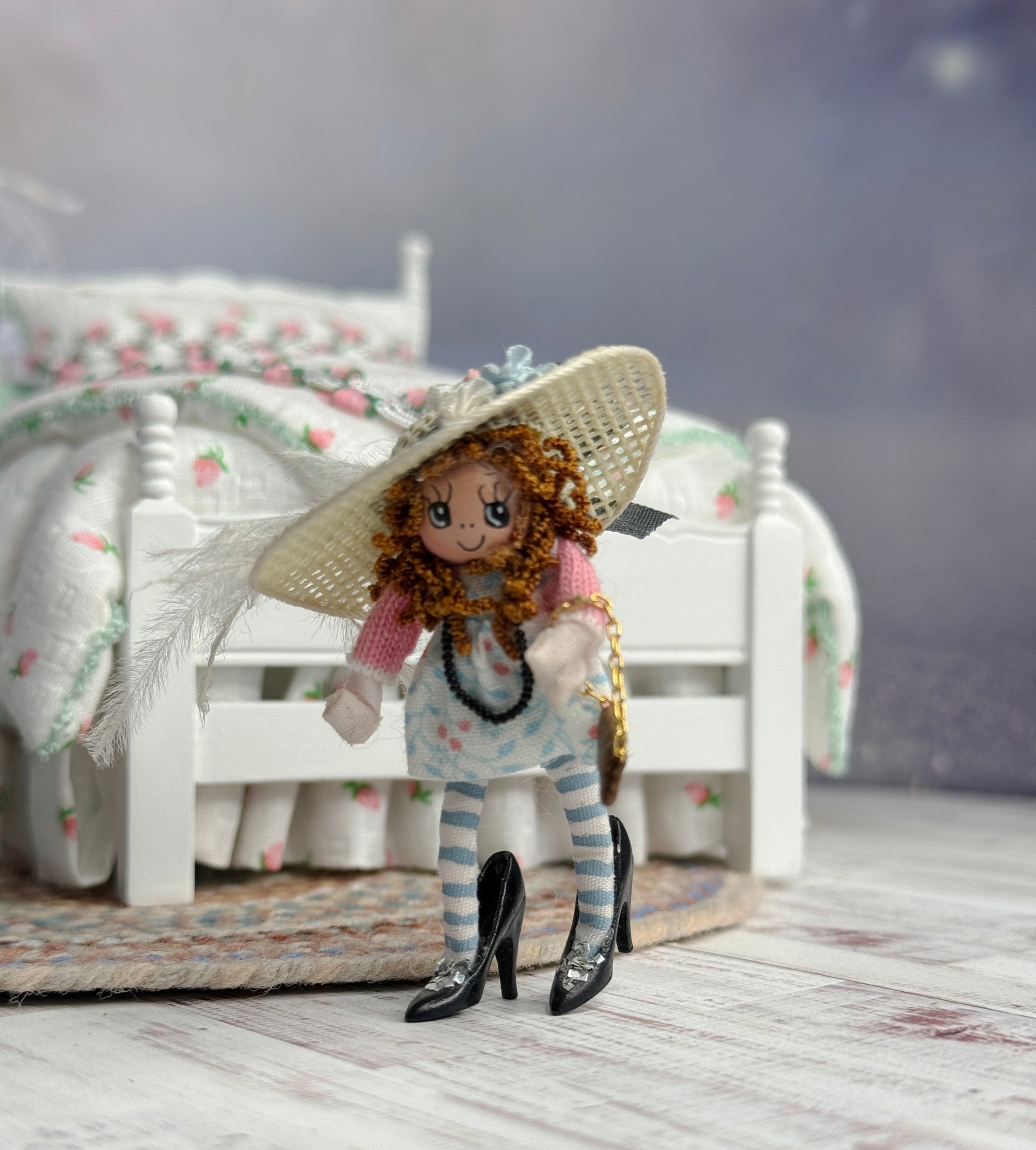 Tiny Clay Little Toy Dolly in Dress Up Clothes & Heels, in front of a bed