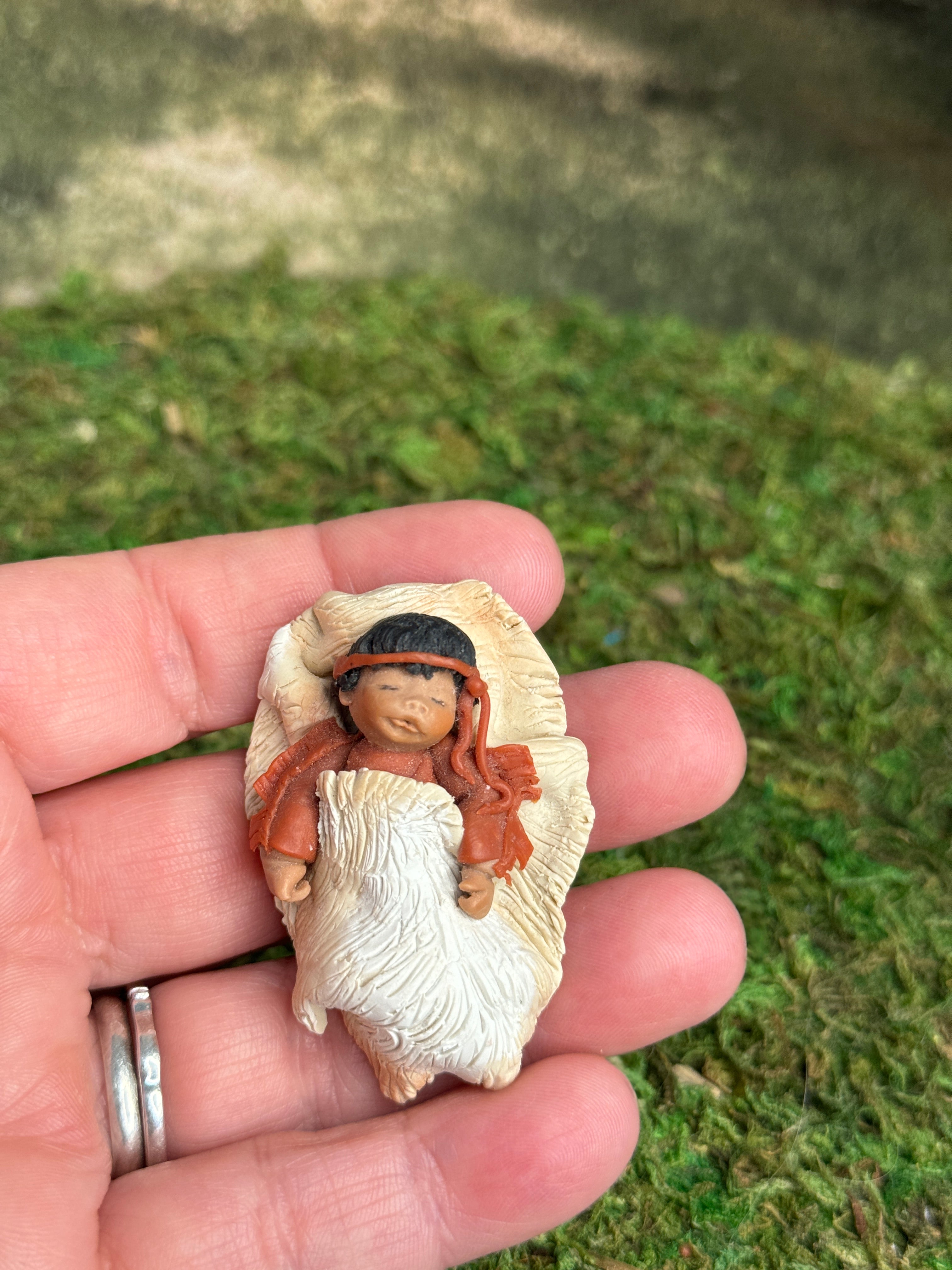 Signed Sculpted Clay Sleeping Native American Baby Doll Figurine, laying in a hand