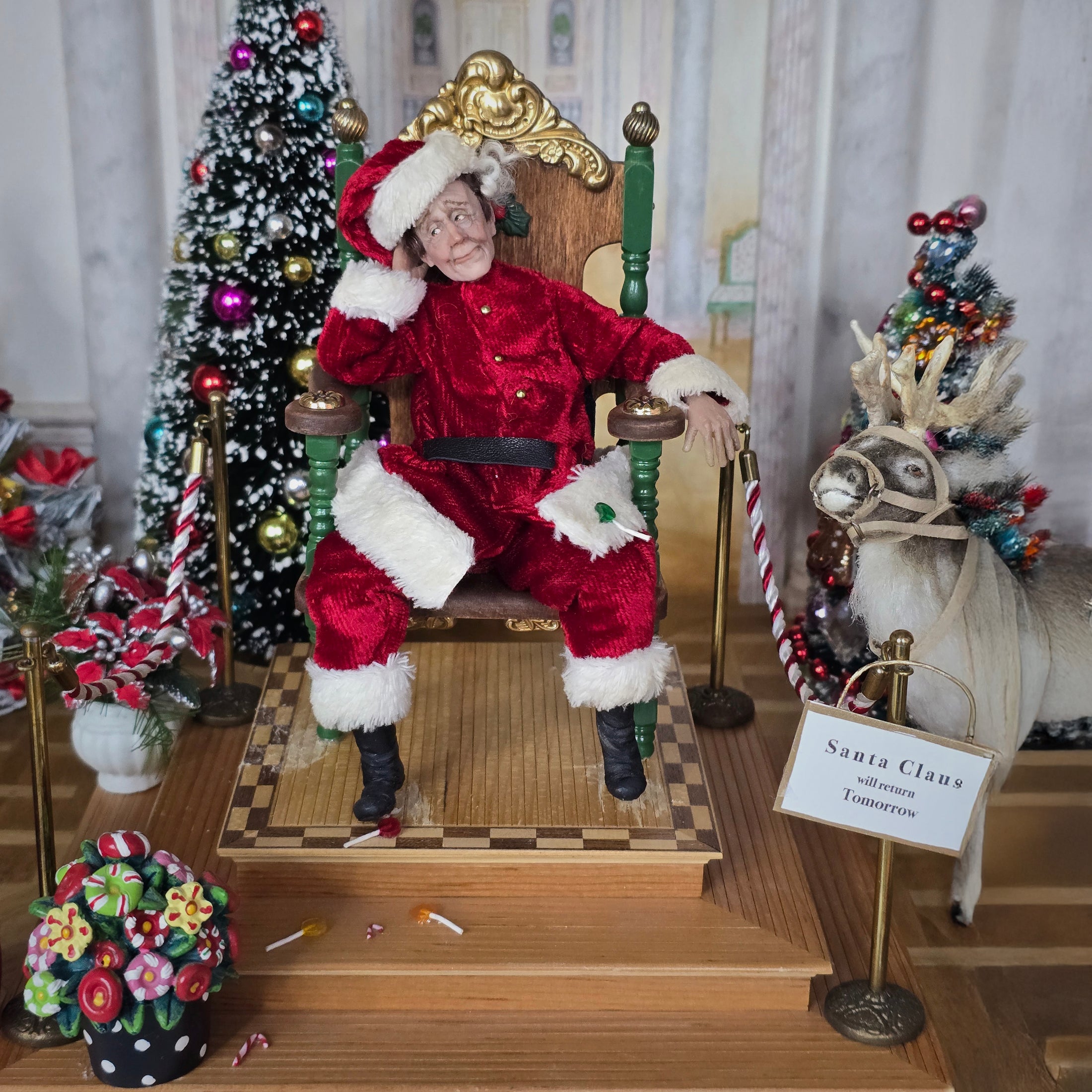 Santa Claus doll sitting on a throne with Christmas decorations around