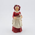Load image into Gallery viewer, Mrs. Claus doll in a red dress and bonnet holding a plate with a cup on a white background

