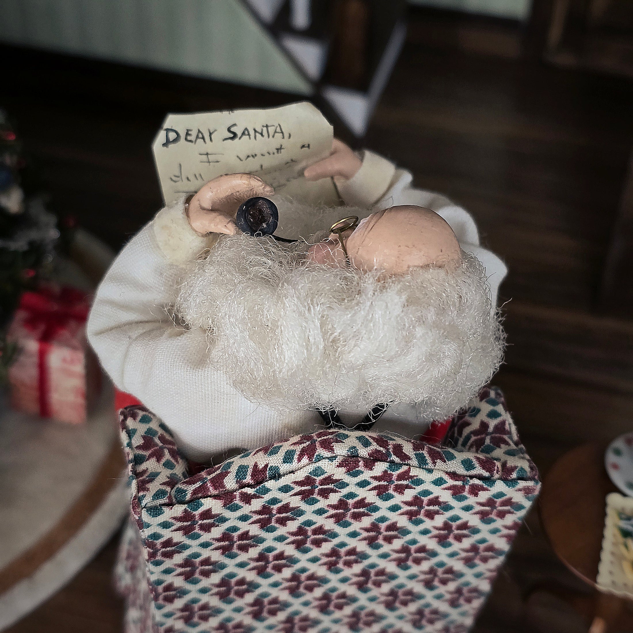 Santa Claus doll reading a child's letter