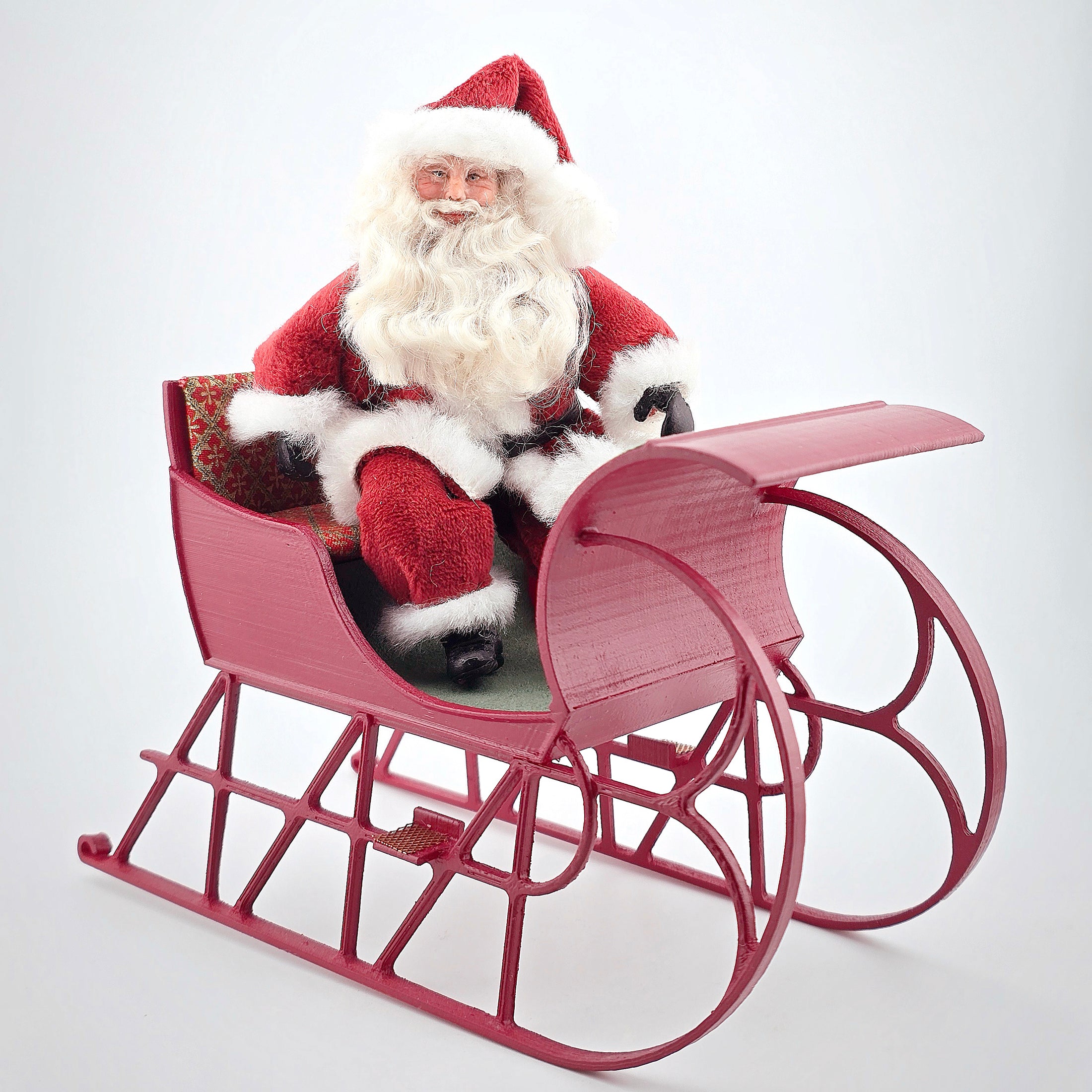 Santa dollhouse doll in his wooden christmas sleigh
