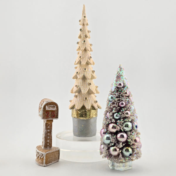Two decorative miniature Christmas trees and a mailbox on a white background