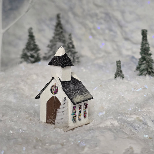 Small model of a church with a snowy background