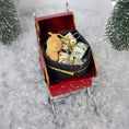 Load image into Gallery viewer, Decorative sleigh ornament with a dog and small packages on a snowy background
