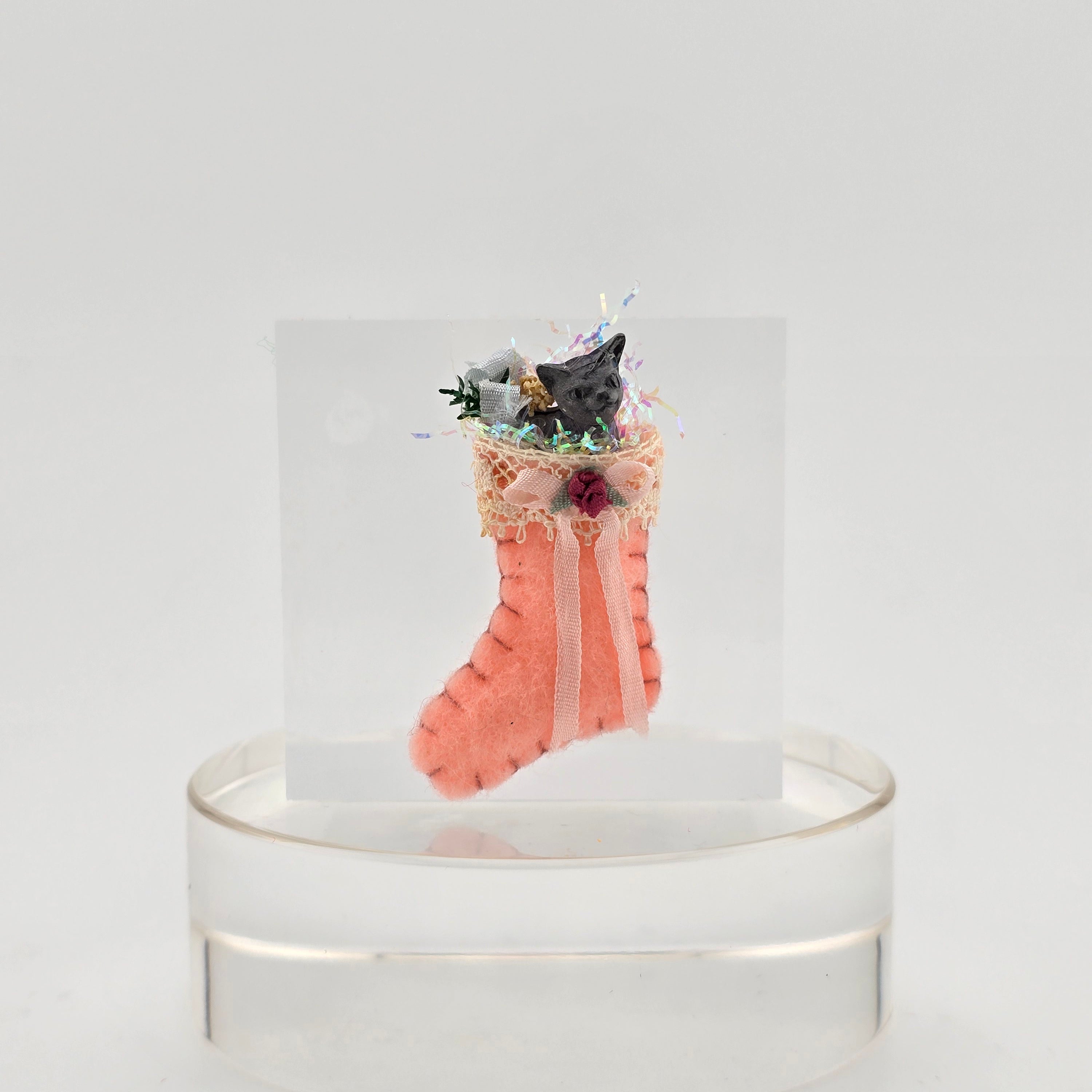 filled miniature Decorative pink stocking against a white background