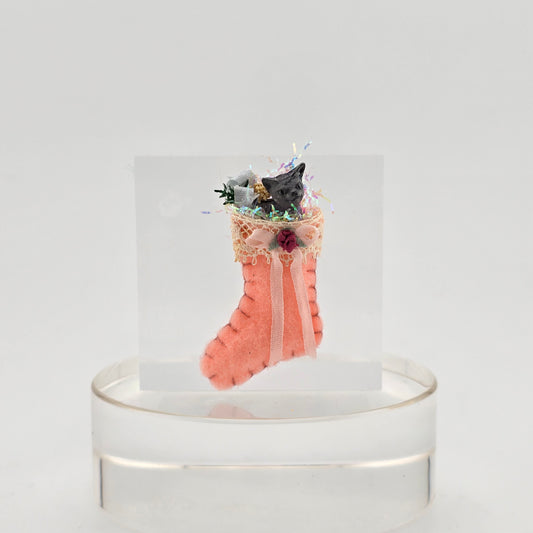 filled miniature Decorative pink stocking against a white background