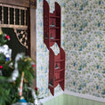Load image into Gallery viewer, Red wall shelf with decorative items against a floral wallpapered wall.
