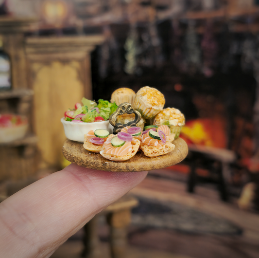 Hand holding a miniature plate with food items against a blurred indoor background