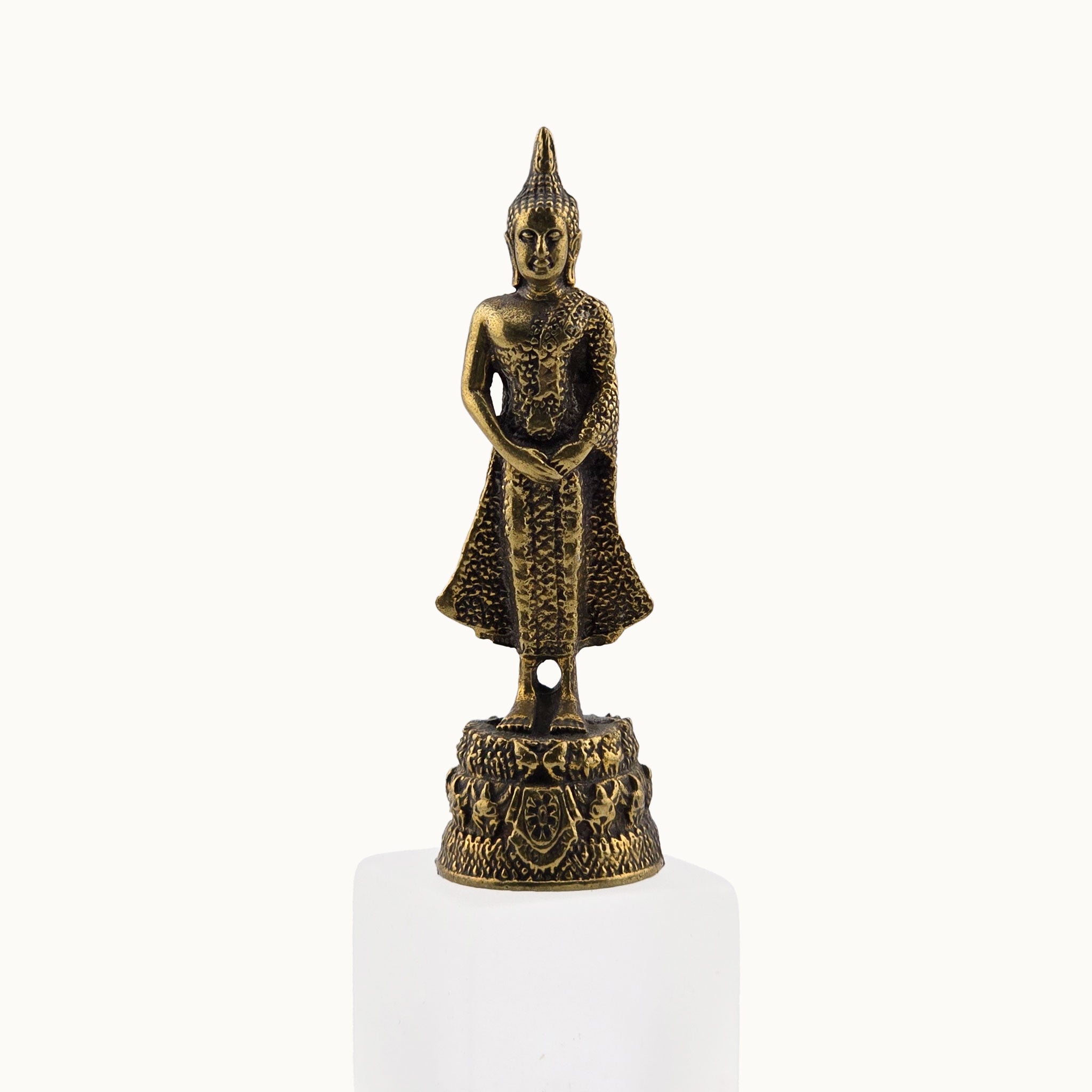 Bronze Buddha statue on a white pedestal with a white background