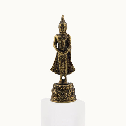 Bronze Buddha statue on a white pedestal with a white background