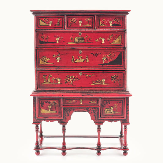 Red chinoiserie wooden cabinet with decorative elements on a white background, Alan Barnes