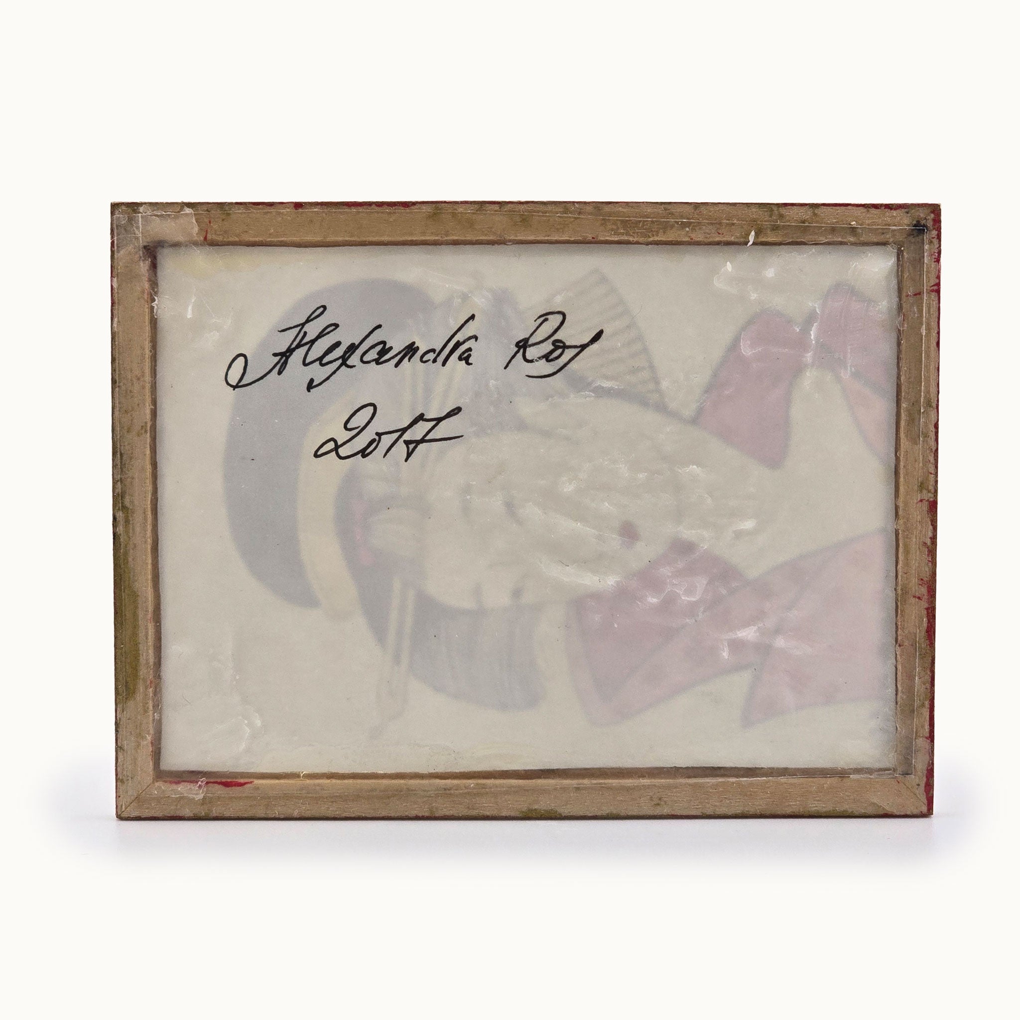 Framed artwork with a signature of Alexandra R., on a white background