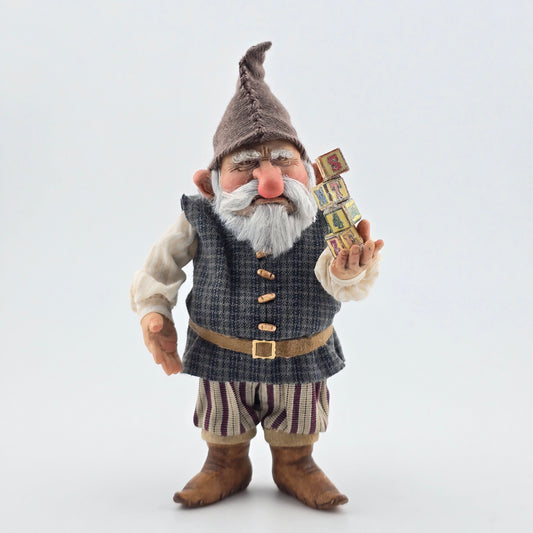 Sharon Cariola Elf dollhouse doll holding small boxes on a white background