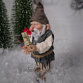 Load image into Gallery viewer, Sharon Cariola Elf dollhouse doll  in a snowy landscape holding a box of matches.
