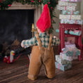 Load image into Gallery viewer, Clay elf character in a checkered shirt and brown overalls standing in front of a fireplace with Christmas decorations.
