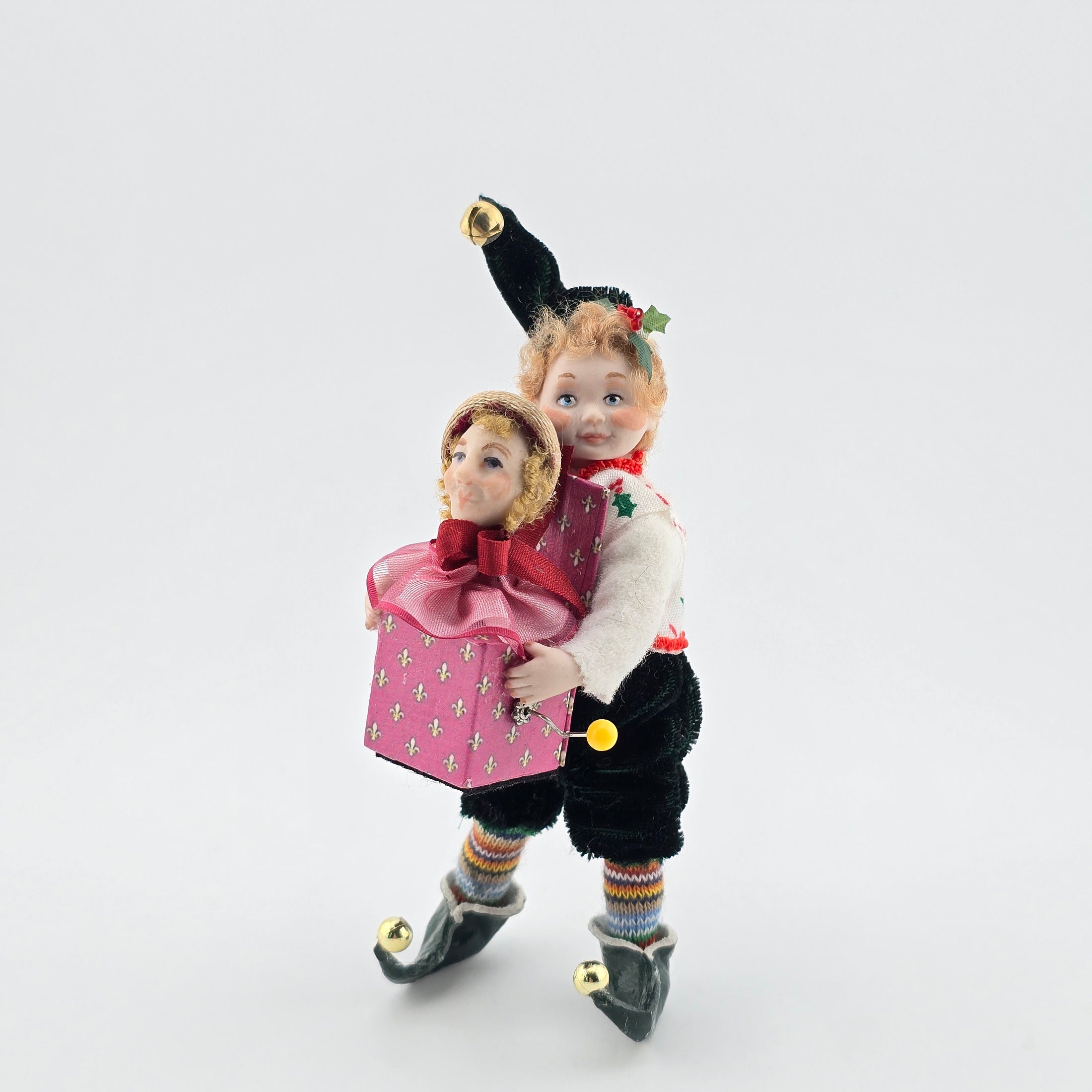 Elf boy doll carrying jack-in-the-box toy