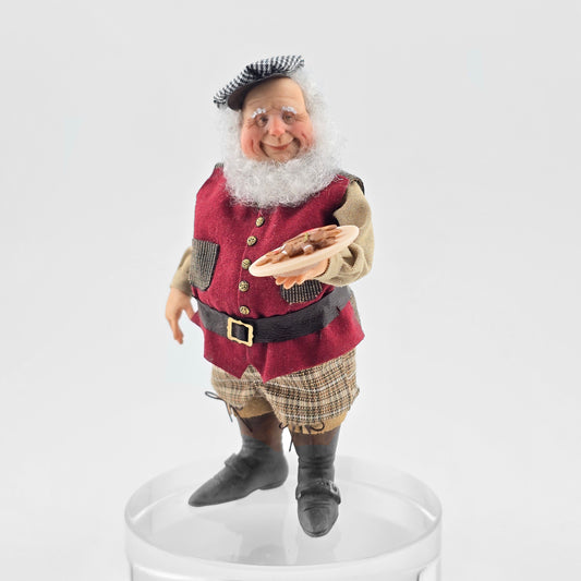 Old Christmas Elf doll in traditional attire on a white background